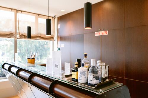 a glass counter with bottles on it in a kitchen at Hotel Conde de Agueda in Águeda