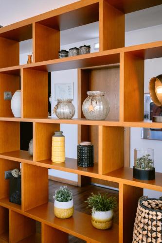 a wooden shelf with pots and vases on it at Hotel Conde de Agueda in Águeda