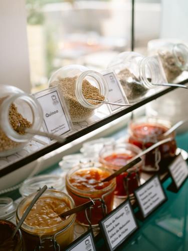 a display case in a store filled with jars of food at Hotel Conde de Agueda in Águeda