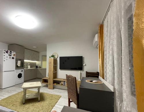 a living room with a table and a kitchen at Studio Kikki Sozopol in Sozopol