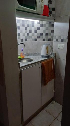 a kitchen with a sink and a counter top at TSEliot Bed&Breakfast in Banfield