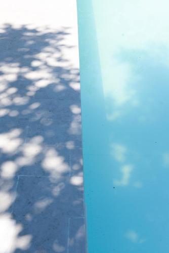 a blue pole with a shadow on the ground at Casa Veientana in Labaro