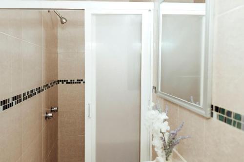 a bathroom with a shower with a glass door at Hotel Rex in Toluca