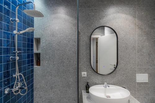 a bathroom with a sink and a mirror at Prado Apartments in Pristina