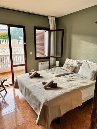 a bedroom with a large bed with towels on it at Apartment Tres Palmeras with pool in Vinarós