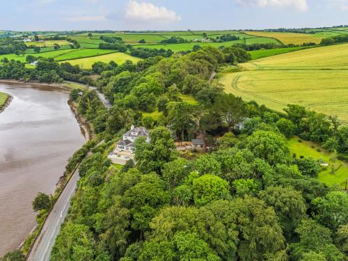 an aerial view of a house on a hill next to a river at Mallacleave House in Bideford
