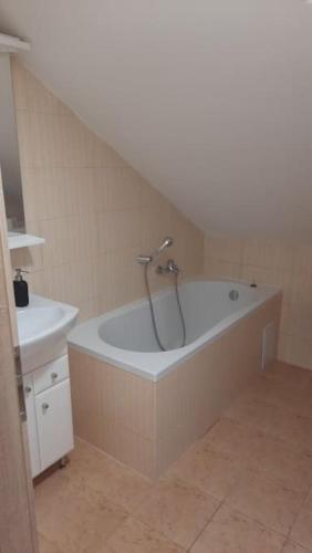 a bathroom with a bath tub and a sink at útulný podkrovní byt v centru Třebíče in Třebíč