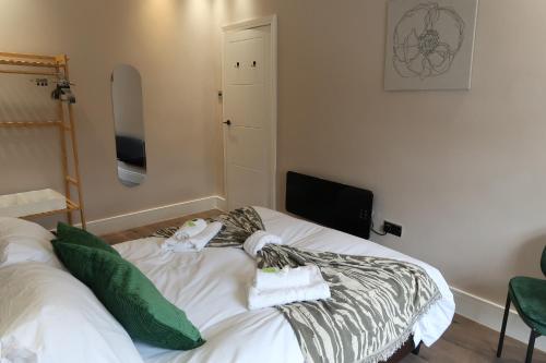 a bedroom with a bed with towels on it at Casa Bella In Sherborne's Historic Quarterlocal in Sherborne