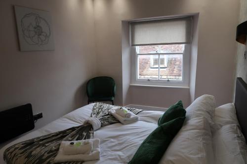 a bed in a room with a window at Casa Bella In Sherborne's Historic Quarterlocal in Sherborne