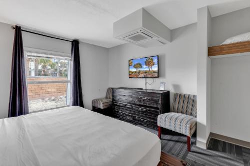a bedroom with a large bed and a window at Holiday Shores Myrtle Beach in Myrtle Beach