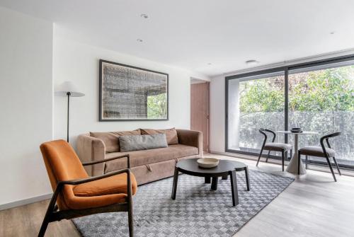 a living room with a couch and a table at Río Nazas 23 by Blueground in Mexico City