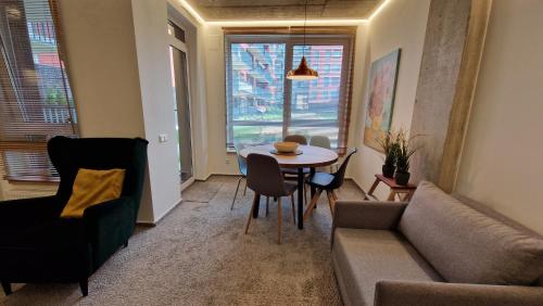 a living room with a couch and a table at Kauno-Algirdo Luxury apartments in Vilnius