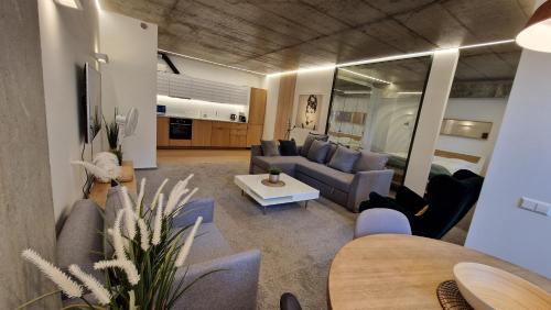 a living room with a couch and a table at Kauno-Algirdo Luxury apartments in Vilnius