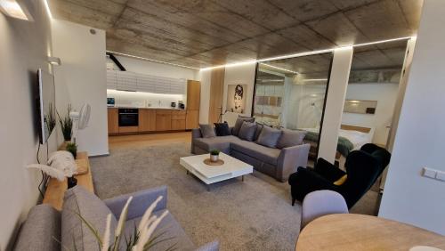 a living room with a couch and a table at Kauno-Algirdo Luxury apartments in Vilnius