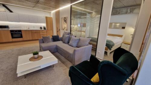 a living room with a couch and a bed at Kauno-Algirdo Luxury apartments in Vilnius