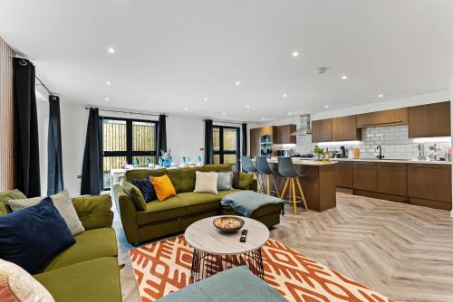a living room with a couch and a table at The Stylish Leeds Escape - Games Room in Leeds