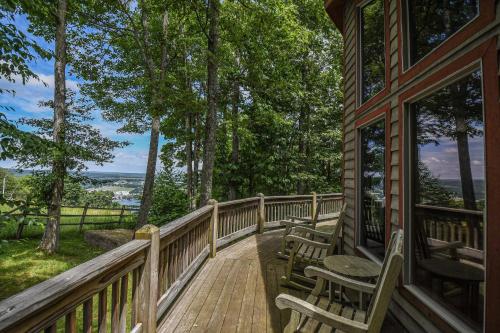 a deck with chairs and tables on a house at One Ski Hill in McHenry