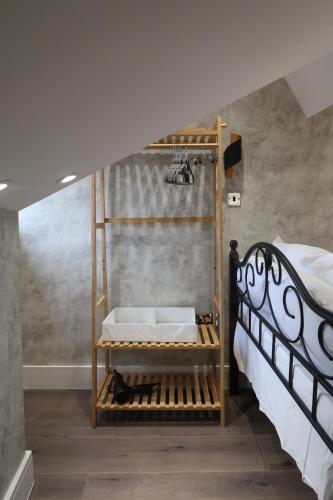 a bedroom with a bunk bed with a ladder at The Loft At Sherborne's Historic Quarter Local in Sherborne