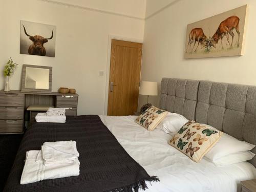 a bedroom with a large bed with a bedspread at Market Place Serviced Apartments, Leek in Leek