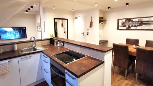 a kitchen with a sink and a counter top at Luxor City Apartments in Lienz