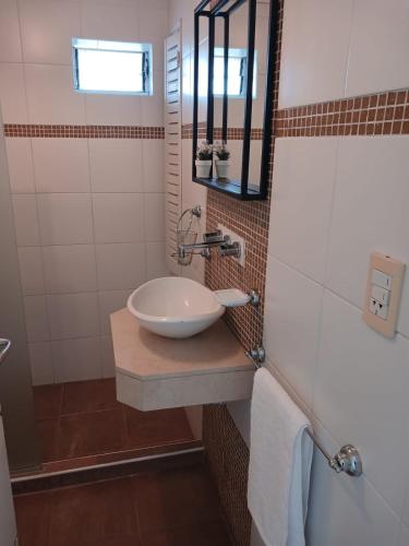 a bathroom with a sink and a mirror at Departamento centrico in Tandil