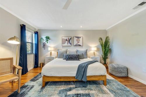 a bedroom with a large bed and two lamps at Luxury Home, Heated Saltwater Pool, 5-Min to Beach in Seminole