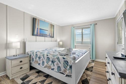 a white bedroom with a bed and a sink at Chateau By the Sea Oceanfront Unit H2 in Myrtle Beach
