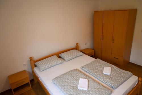 a bedroom with two twin beds and a cabinet at Apartman Pavić in Livno
