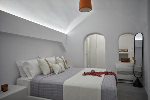 a white bedroom with a bed with white walls at 1949 Cave Residence in Pirgos