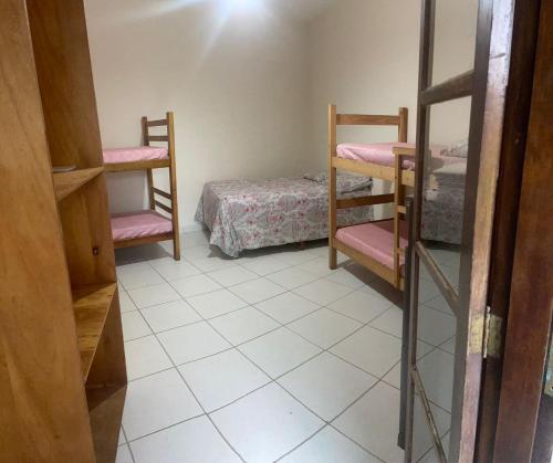 a room with two bunk beds and a bed at Colônia Virtual Net in Itanhaém