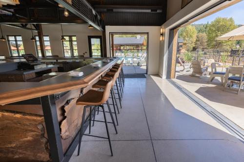 a bar in a restaurant with a long counter and stools at Firefall Ranch Yosemite in Groveland