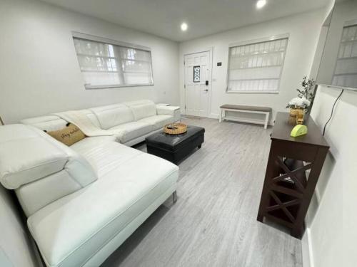 a living room with a white couch and a table at LaBella Suite in Miami