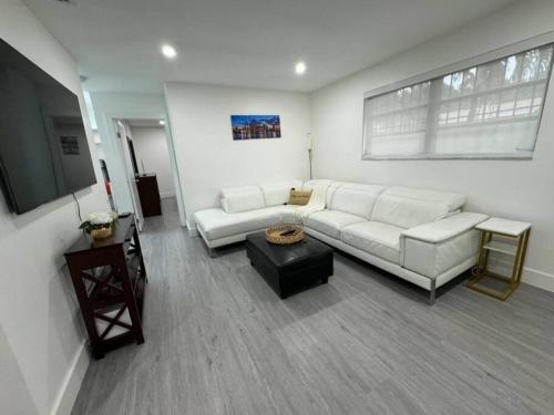a living room with a white couch and a table at LaBella Suite in Miami