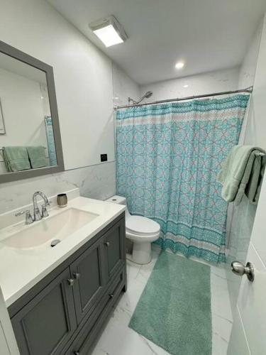 a bathroom with a sink and a toilet and a shower at LaBella Suite in Miami