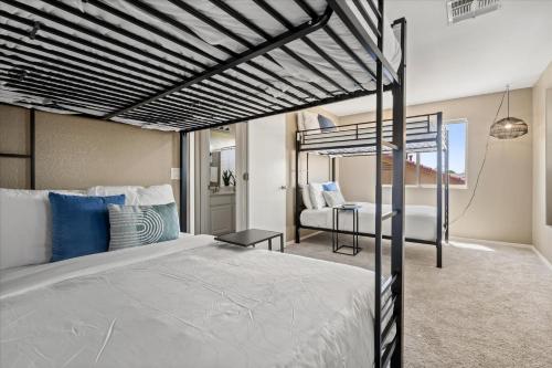 a bedroom with a bunk bed and a living room at Putt Putt Hot Tub Game Room Pool Cornhole in Chandler