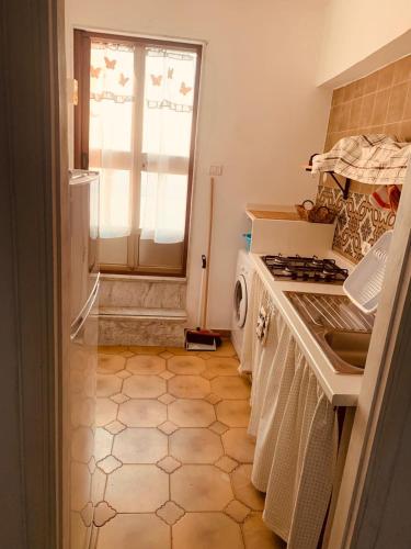 a kitchen with a sink and a stove top oven at B&B Casa Chicchina in Ischitella