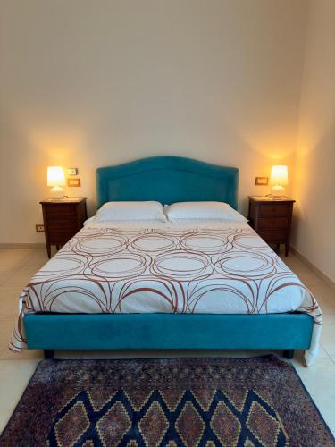 a bedroom with a blue bed with two night stands at LaCasaDiTitti in Chianciano Terme