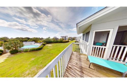 a balcony of a house with a view of a yard at 2 BR Condo in Inlet Point Stunning Views in Pawleys Island