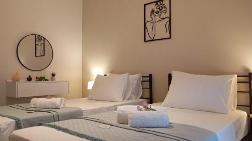 a room with two beds with towels on them at Venetton Garden House Corfu in Gouvia