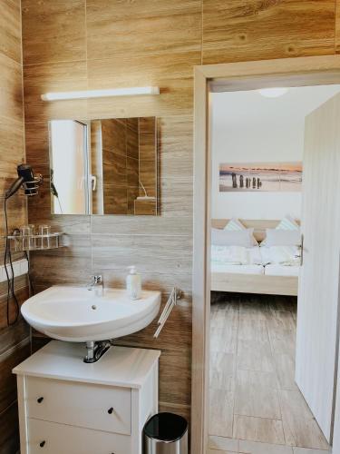 a bathroom with a sink and a bed at Feriendorf Lahnsteiner Höhe in Lahnstein