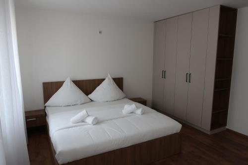 a bedroom with a white bed with white pillows at Old Apartment in Koblenz