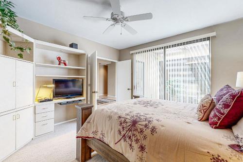 a bedroom with a bed and a flat screen tv at Southern Hills Charm Permit# 65256 in La Quinta
