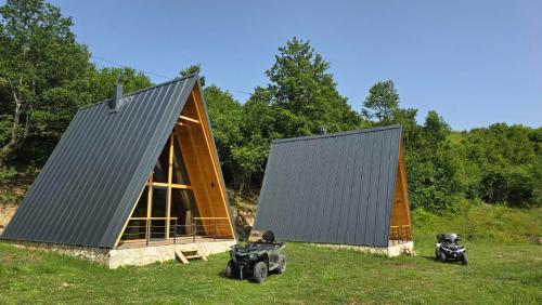 two atvs are parked in front of a tent at OASIS of PEACE 1 in Šavnik
