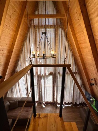 a chandelier in a attic with a large window at OASIS of PEACE 1 in Šavnik
