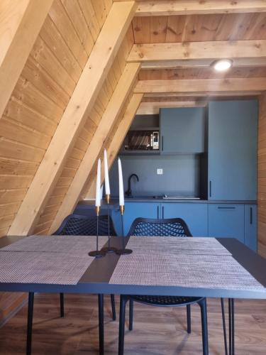 a dining room with a table and a kitchen at OASIS of PEACE 1 in Šavnik