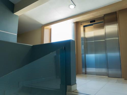 a hallway with a glass door in a building at Hotel Real de La Barca in La Barca