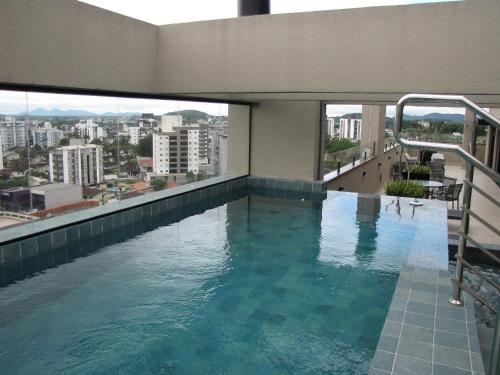 a swimming pool on the top of a building at RCM Vilas - Apartamento 505 in Joinville