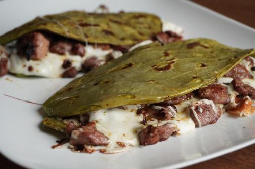 a white plate with a slice of pizza with meat and cheese at Hotel Real de La Barca in La Barca