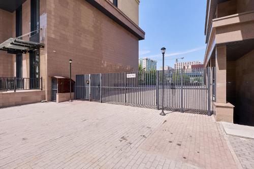 a metal fence in front of a building at Five Business-class rooms in R-house near Mega Center Almaty in Almaty