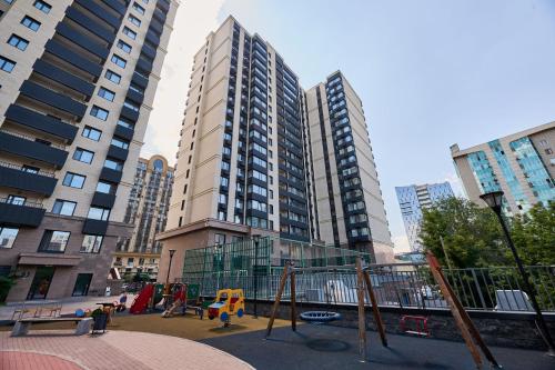 a playground in a city with tall buildings at Five Business-class rooms in R-house near Mega Center Almaty in Almaty
